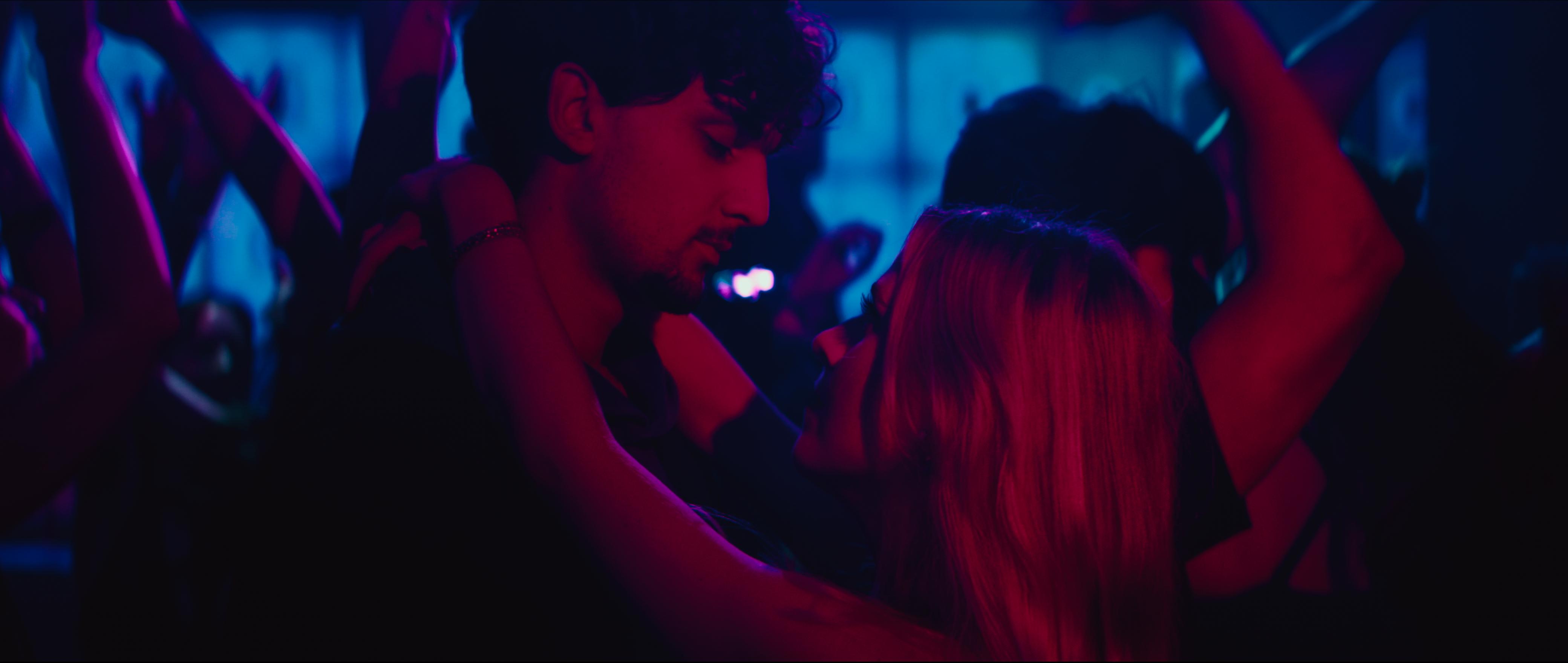 Janosch and Saskia dancing under neon